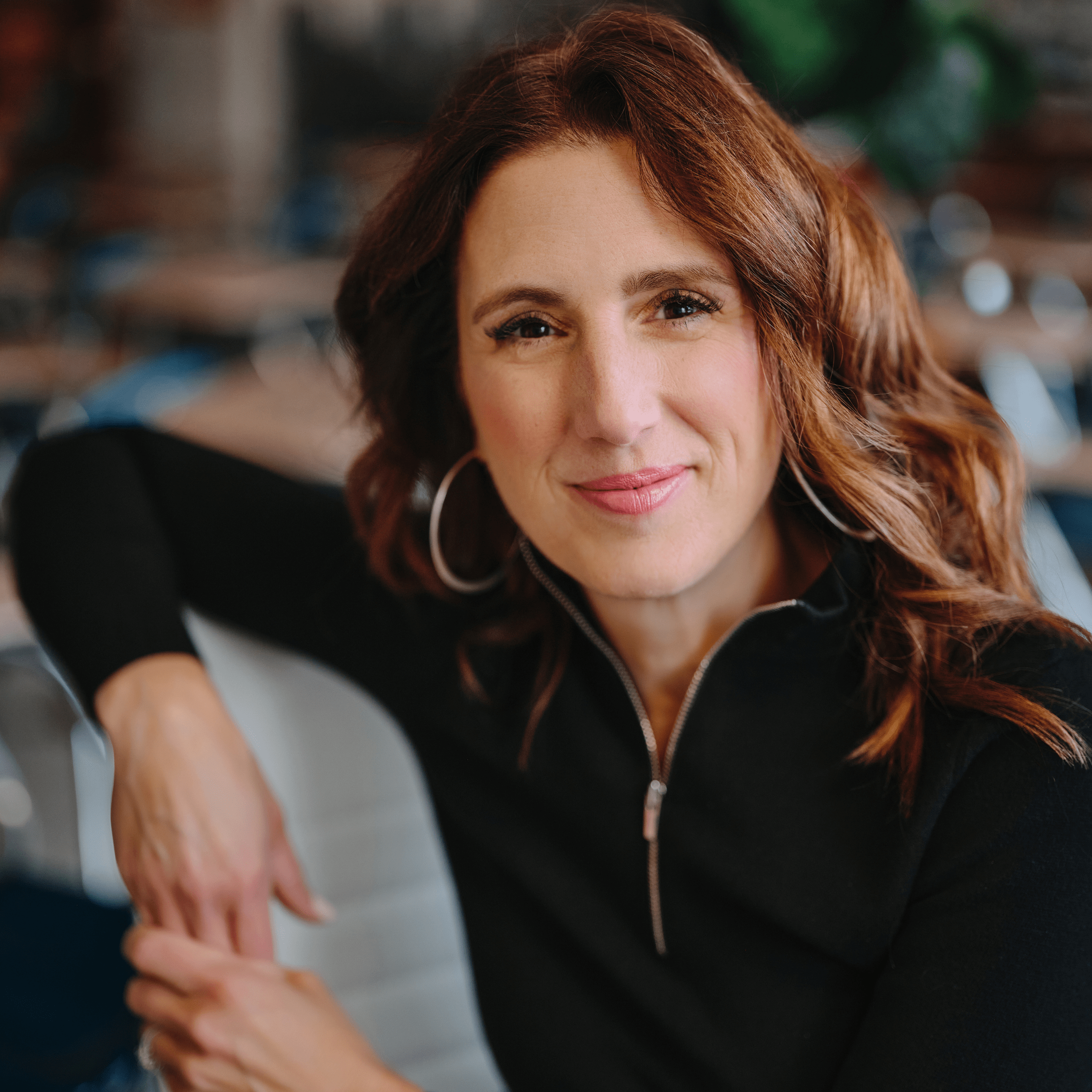 Dr. Kristie smiles at the camera in a headshot, wearing a professional black quarter-zip sweater. Her expression reflects her dedication to promoting inclusion in schools, emphasizing her commitment to creating equitable and welcoming educational environments for all students.