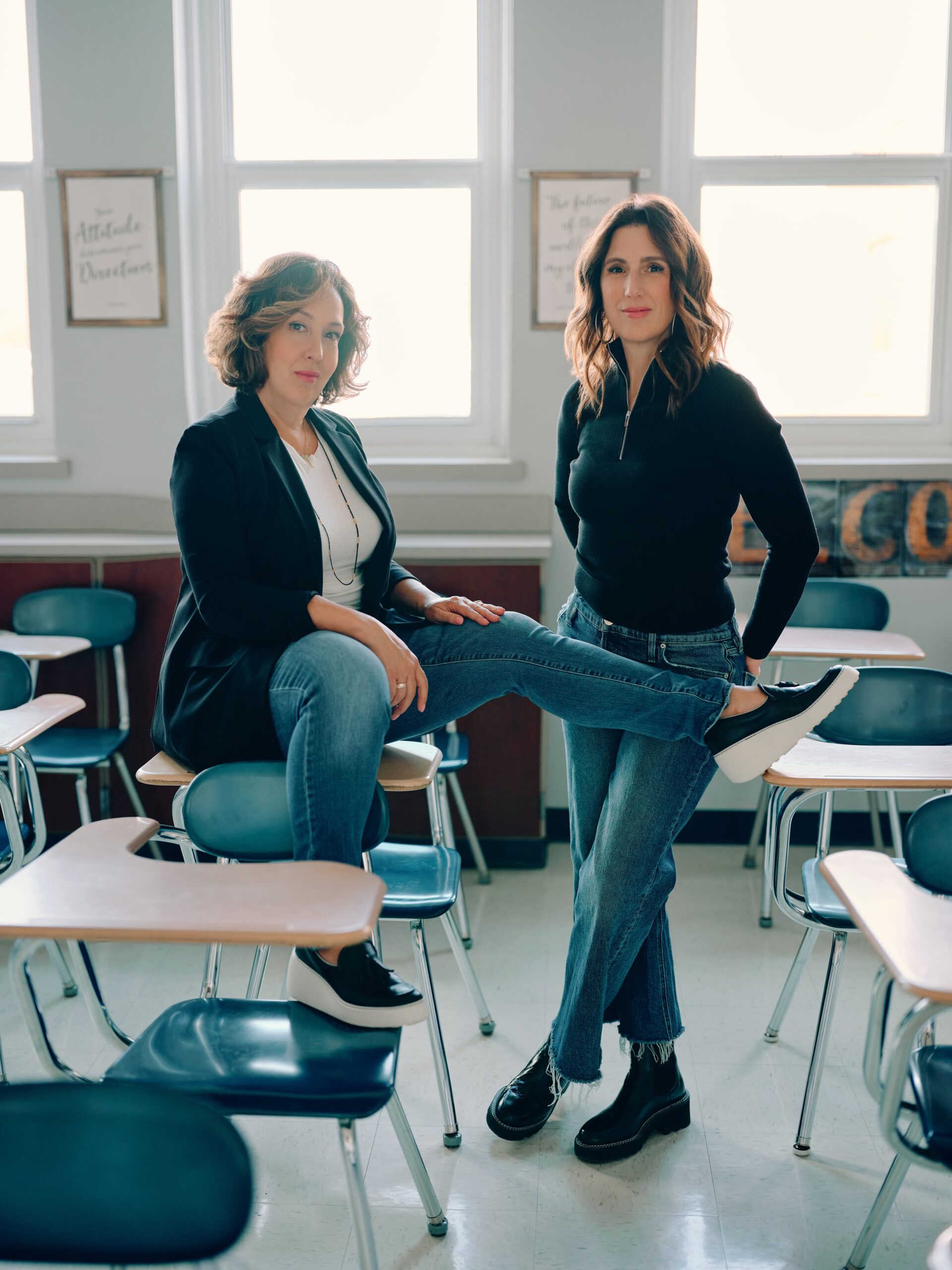 Drs. Julie & Kristie standing between desks in classroom